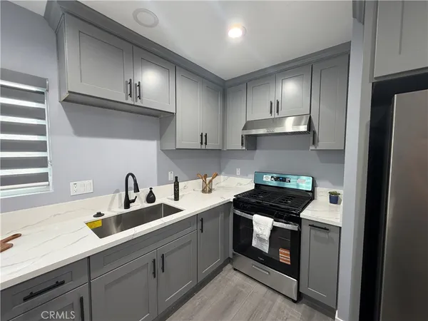 a kitchen with cabinets a sink and appliances