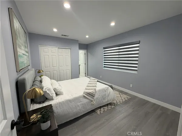 a bedroom with bed and a window