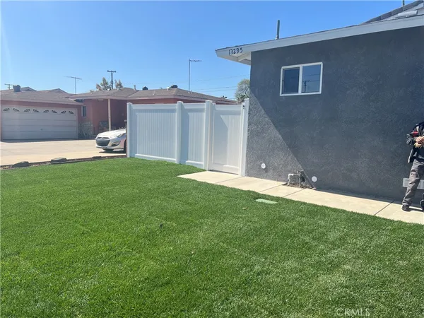 a backyard of a house with table and chairs