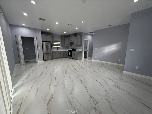 a view of a kitchen with a sink and a refrigerator