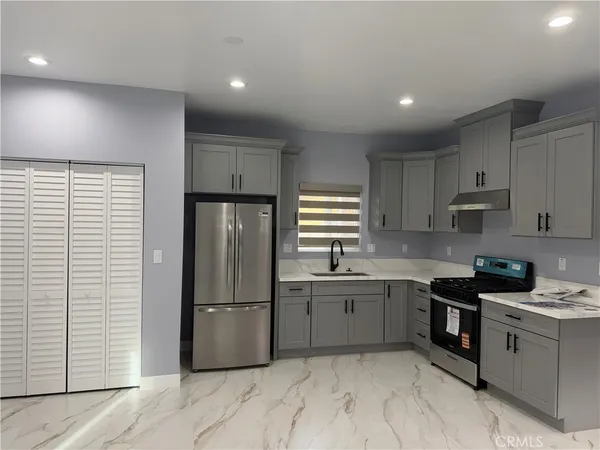a kitchen with a sink stainless steel appliances and cabinets