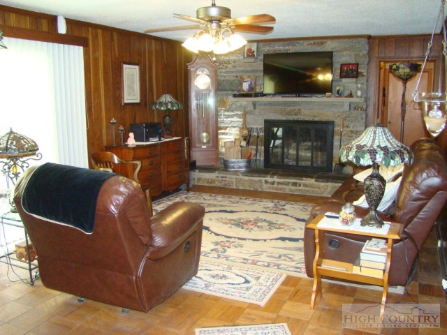 3262 Bamboo Road Boone, NC 28607 - Photo 11 of 12 a living room with furniture a flat screen tv and a fireplace