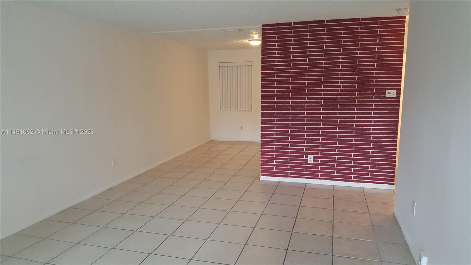 Miami-Dade County Miami, FL 33161 - Photo 11 of 31 a view of wooden door and brick wall