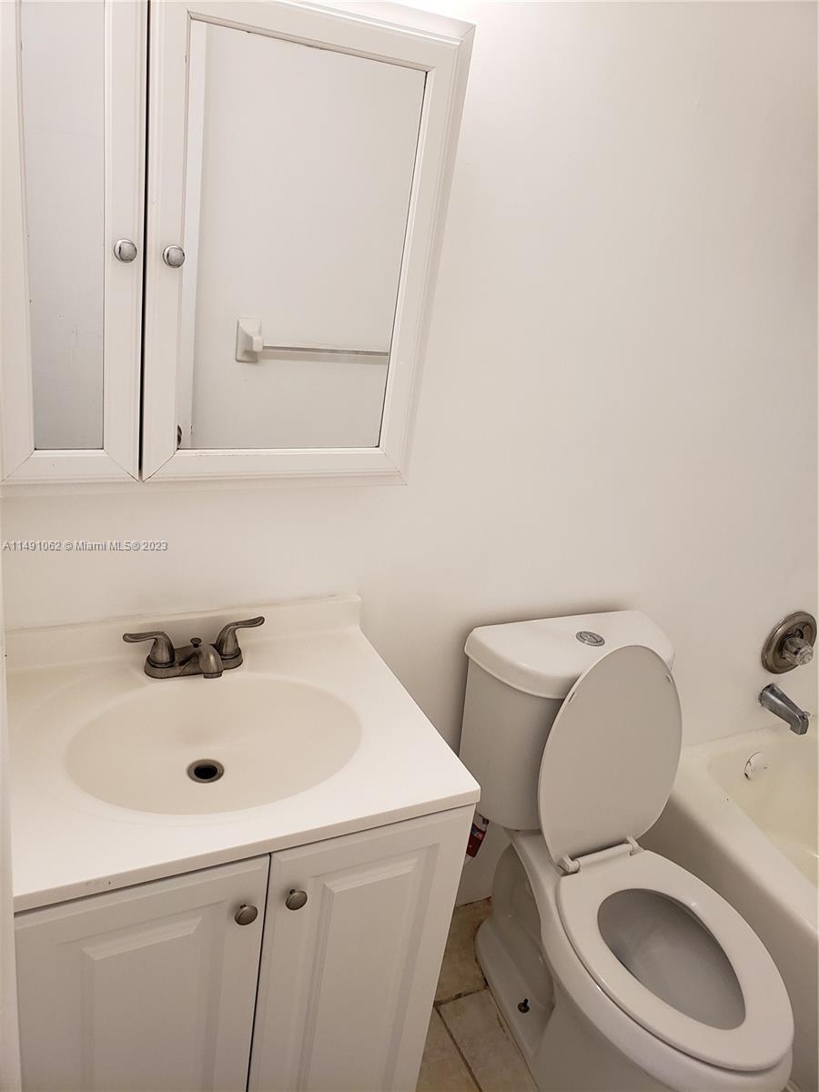 Miami-Dade County Miami, FL 33161 - Photo 17 of 31 a bathroom with a sink and a toilet