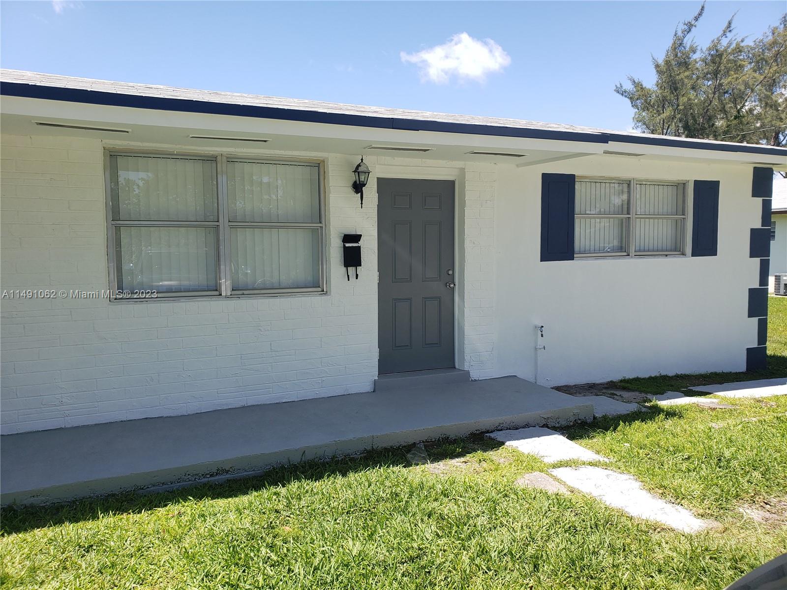 Miami-Dade County Miami, FL 33161 - Photo 20 of 31 a front view of a house with a yard