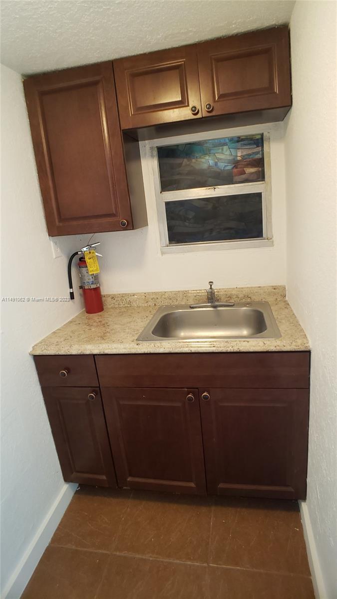 Miami-Dade County Miami, FL 33161 - Photo 22 of 31 a bathroom with a sink and a microwave