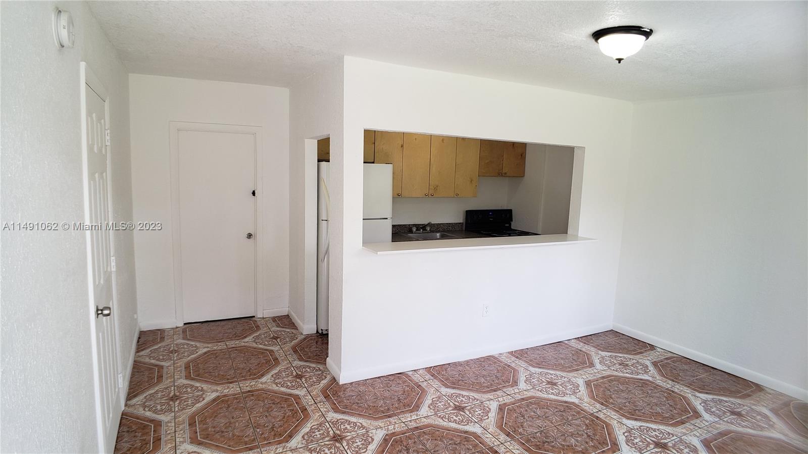 Miami-Dade County Miami, FL 33161 - Photo 30 of 31 a bedroom with a bed and wooden floor