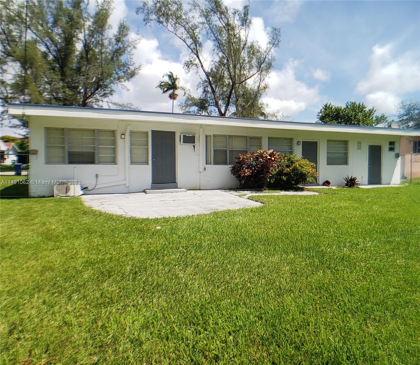 Miami-Dade County Miami, FL 33161 - Photo 7 of 31 a front view of house with a garden and trees