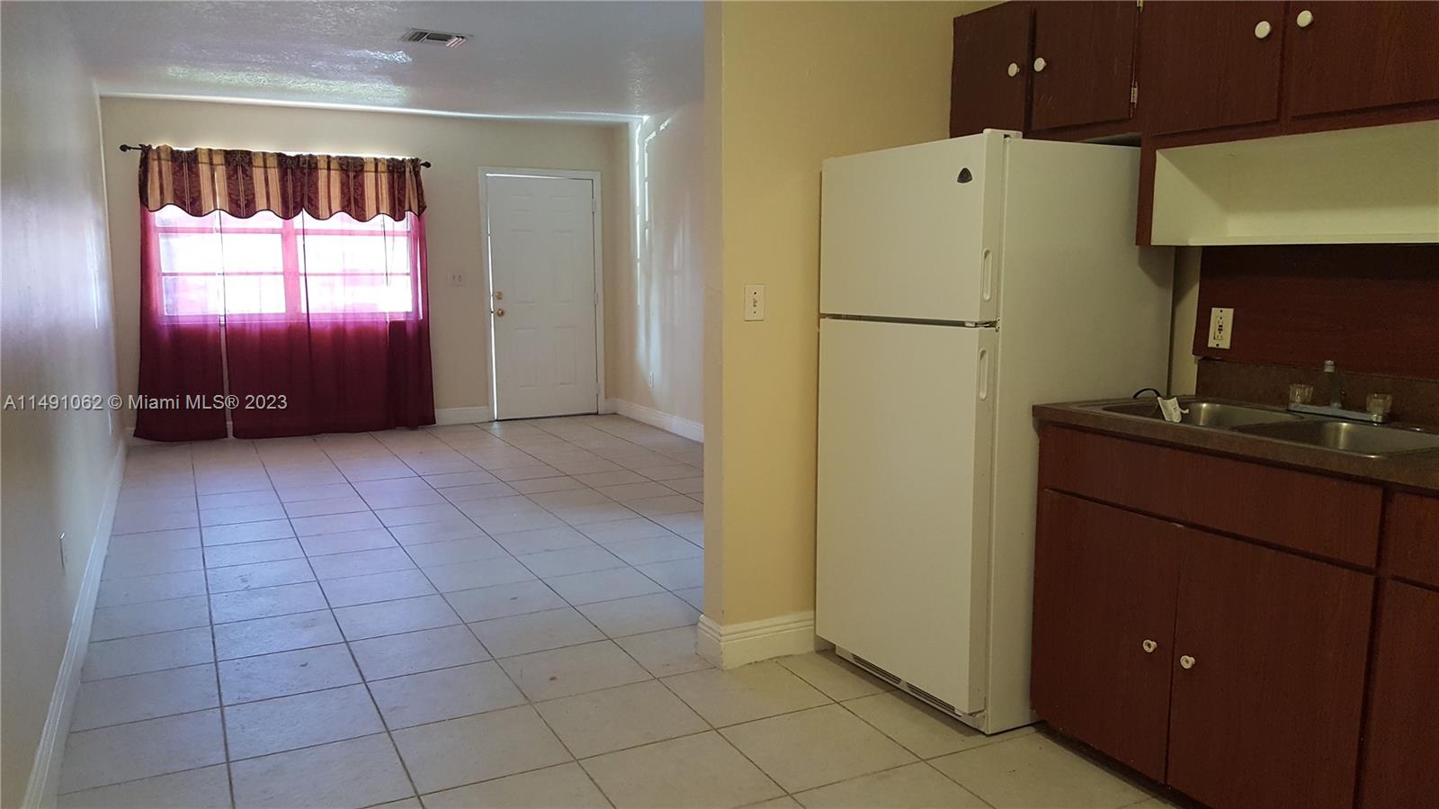 Miami-Dade County Miami, FL 33161 - Photo 10 of 31 a kitchen with a refrigerator and a sink