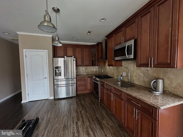 a kitchen with a refrigerator sink and microwave