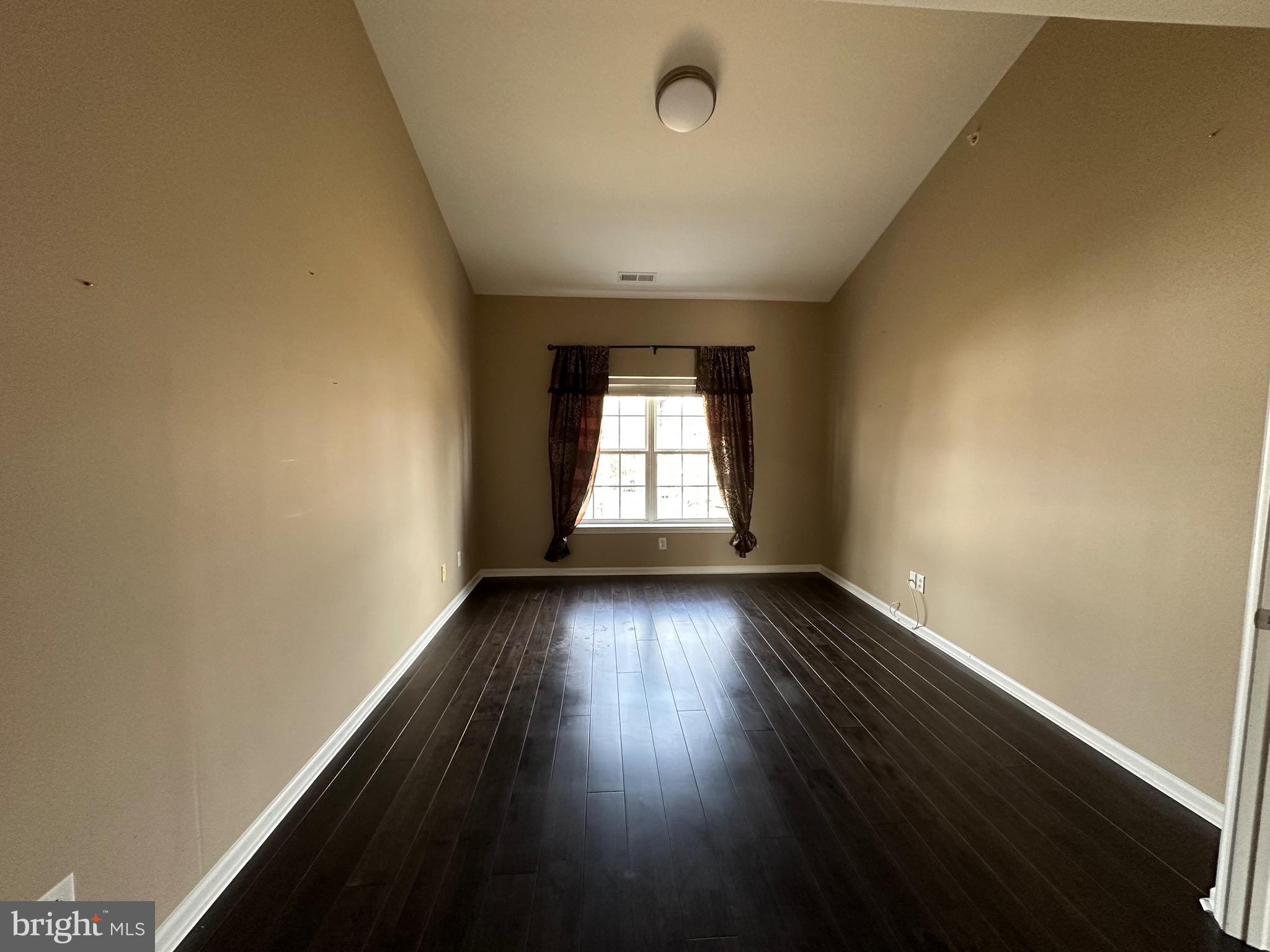 290 Byberry Road, Unit 2 Philadelphia, PA 19116 - Photo 9 of 12 an empty room with wooden floor and windows