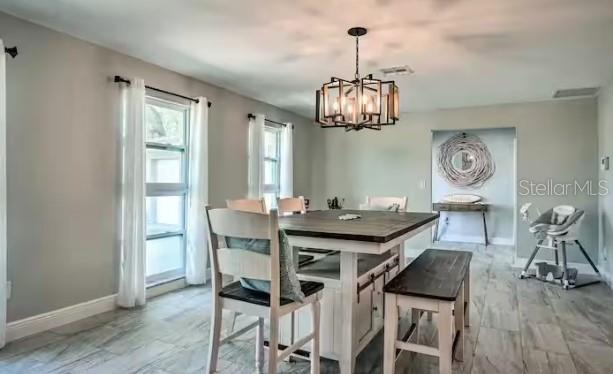 2 Booth Boulevard Safety Harbor, FL 34695 - Photo 2 of 9 a view of a dining room with furniture wooden floor and chandelier