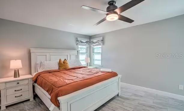 2 Booth Boulevard Safety Harbor, FL 34695 - Photo 3 of 9 a bedroom with a large bed and a ceiling fan