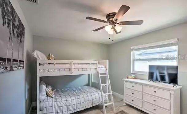 2 Booth Boulevard Safety Harbor, FL 34695 - Photo 4 of 9 a bedroom with a bed and a dresser