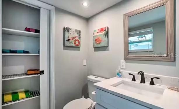 2 Booth Boulevard Safety Harbor, FL 34695 - Photo 6 of 9 a bathroom with a toilet sink and mirror