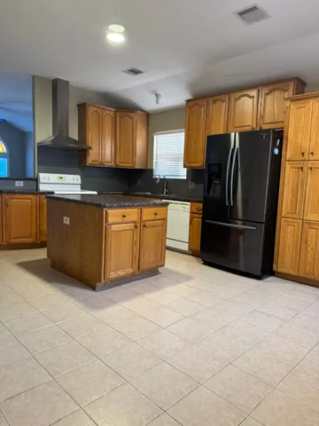 a kitchen with a refrigerator and window