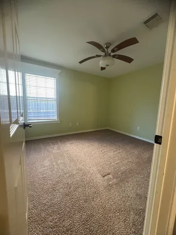 a view of room with window and ceiling fan