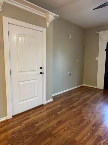 a view of a backyard with plants and wooden fence