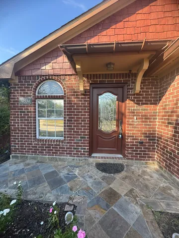 a view of a hallway with wooden floor and windows