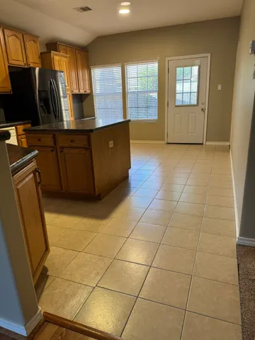 a kitchen with stainless steel appliances granite countertop a sink stove and cabinets