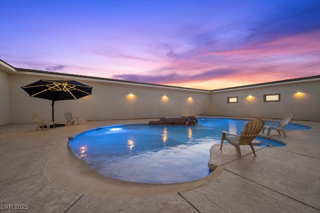 640 Quail Covey Road Henderson, NV 89002 - Photo 65 of 75 Pool at dusk featuring a patio area