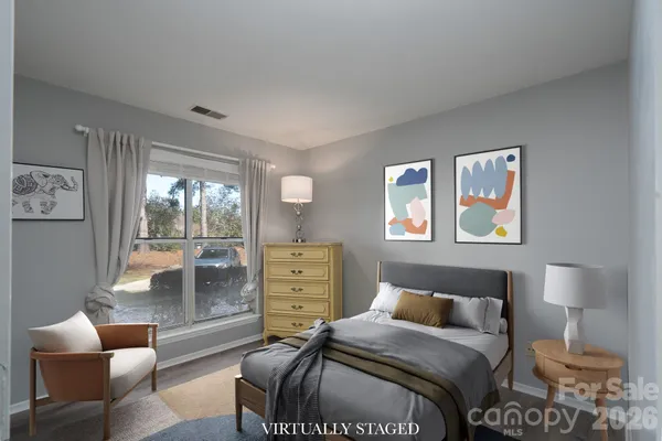 a view of a room with wooden floor and white walls