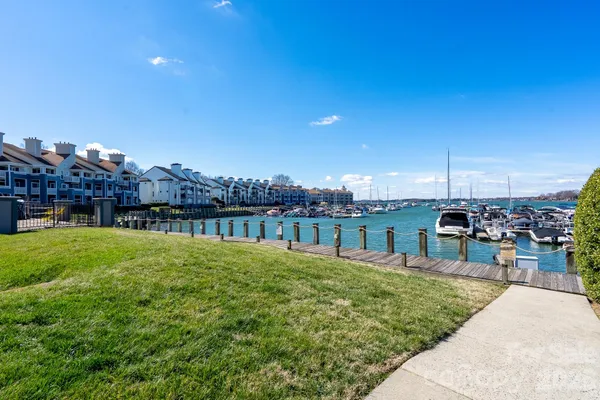 an aerial view of a house with swimming pool and outdoor seating