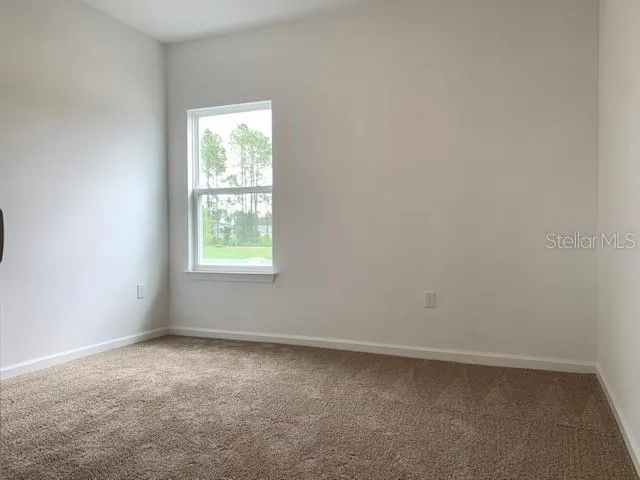 an empty room with closet area