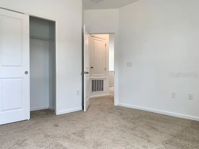 a view of an empty room with windows