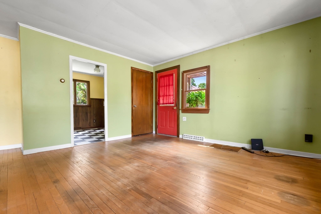 71 Union Street Hamilton, MA 01982 - Photo 4 of 21 a view of an empty room with wooden floor and a window