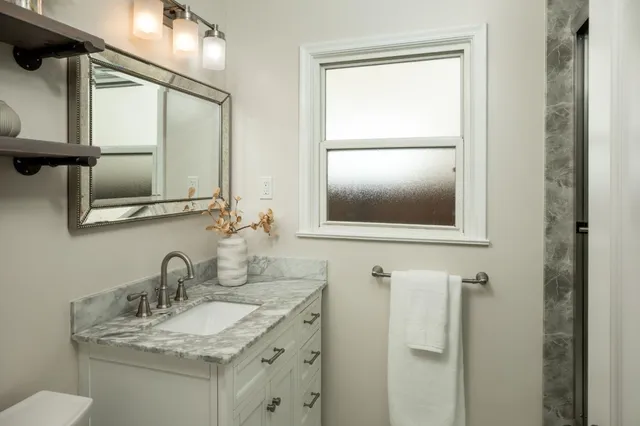 a view of a backyard with wooden fence