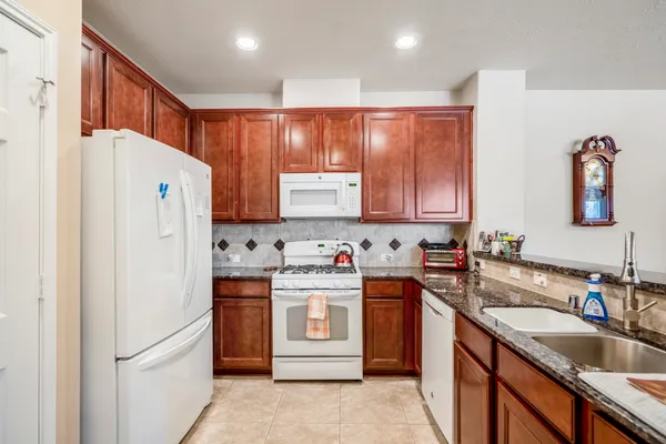 a kitchen with stainless steel appliances granite countertop a refrigerator sink and cabinets