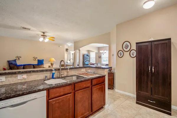 a kitchen with stainless steel appliances granite countertop a refrigerator sink and stove