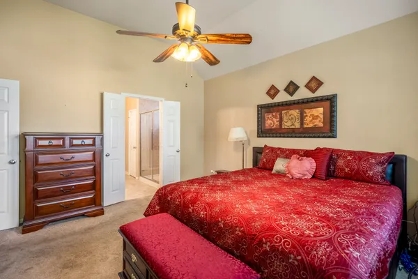 a bedroom with a bed and a chandelier