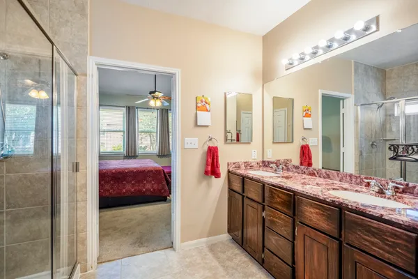 a en suite bathroom with a glass shower door and a bathroom