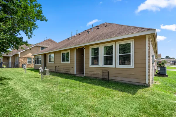 a view of backyard of house with green space and porch