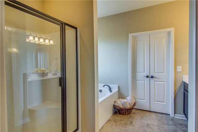2021 Lincoln Road Spring Hill, TN 37174 - Photo 11 of 19 Owner's bath featuring separate tub and shower. Double vanities and walk in closet.