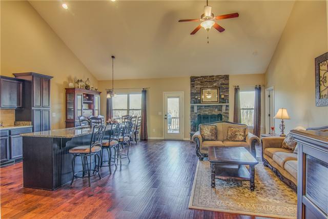 2021 Lincoln Road Spring Hill, TN 37174 - Photo 4 of 19 Open living room with hardwood and wood burning fireplace with stone accent.