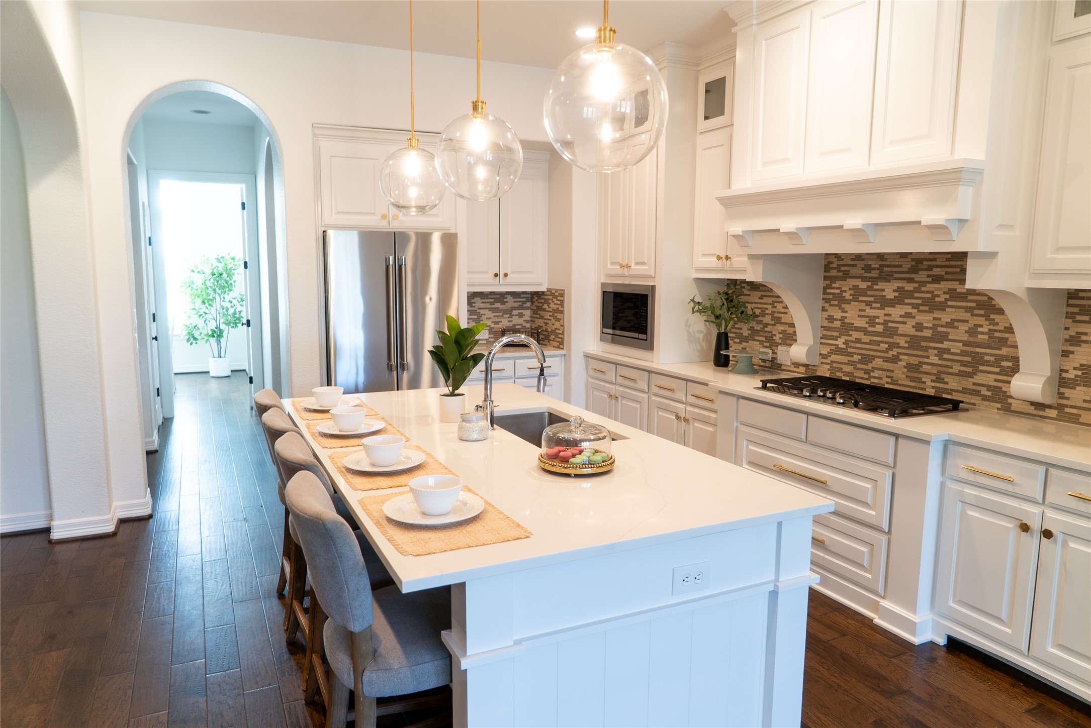 8801 Wild Rice Cove Austin, TX 78738 - Photo 5 of 40 Statement pendants illuminate the oversized island, while canned lights