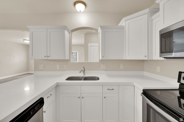 1823 North Crest Road Saratoga Springs, UT 84045 - Photo 9 of 18 Kitchen featuring stainless steel appliances and white cabinetry