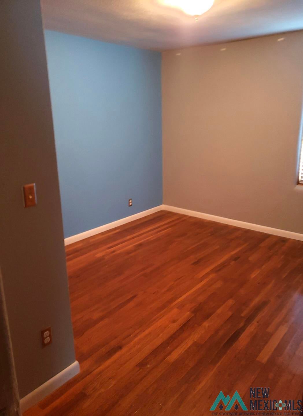 1375 Brilliant Street Raton, NM 87740 - Photo 10 of 19 Unfurnished room featuring dark wood-style flooring