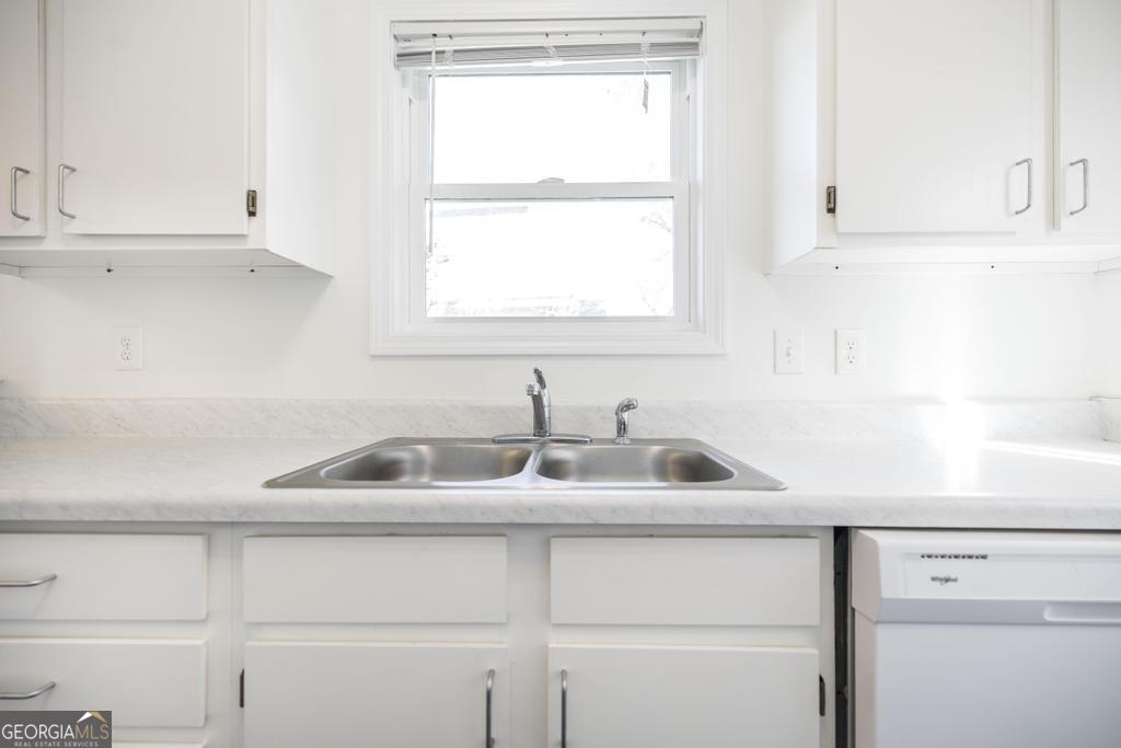 338 Monroe Street Macon, GA 31201 - Photo 13 of 25 a kitchen with white cabinets and a sink