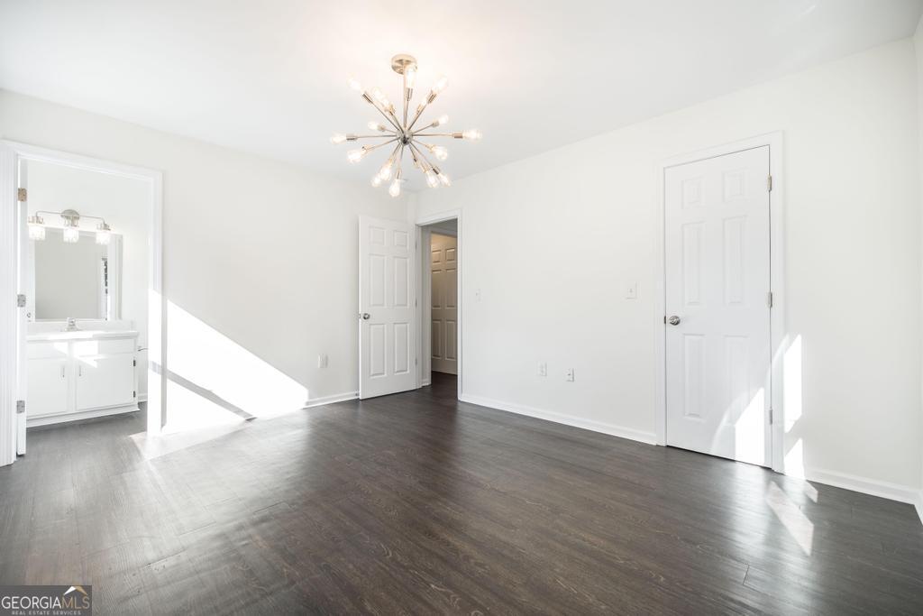 338 Monroe Street Macon, GA 31201 - Photo 16 of 25 an empty room with wooden floor fan and windows