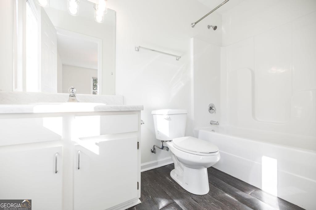 338 Monroe Street Macon, GA 31201 - Photo 17 of 25 a bathroom with a sink toilet and a mirror