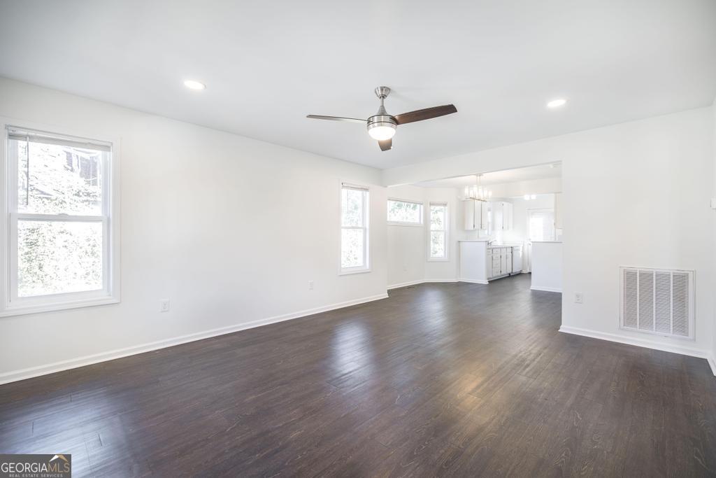 338 Monroe Street Macon, GA 31201 - Photo 7 of 25 a view of an empty room with wooden floor and a window
