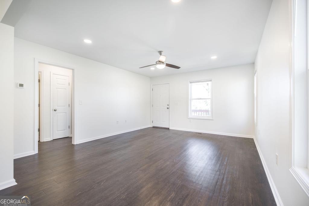 338 Monroe Street Macon, GA 31201 - Photo 8 of 25 an empty room with wooden floor and windows
