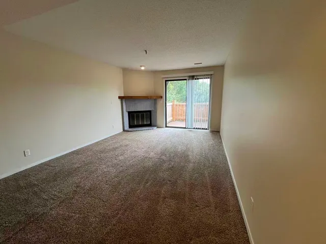 a view of empty room with a fireplace