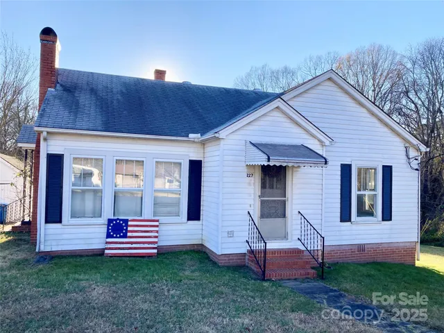 a front view of a house with a garden and yard