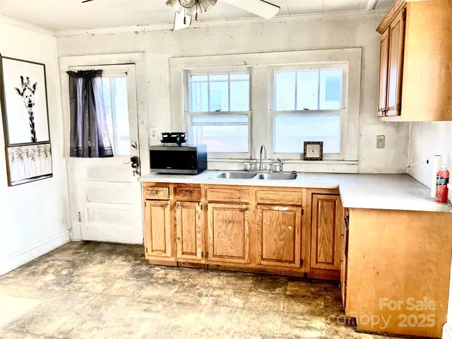 a kitchen with stainless steel appliances granite countertop a sink stove and cabinets