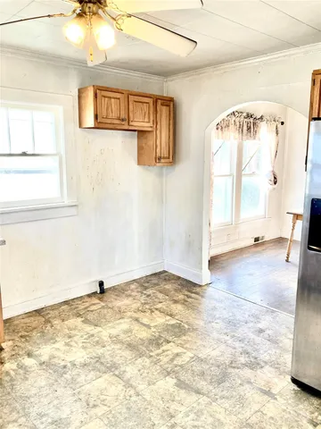 a view of a livingroom with wooden floor and a large window